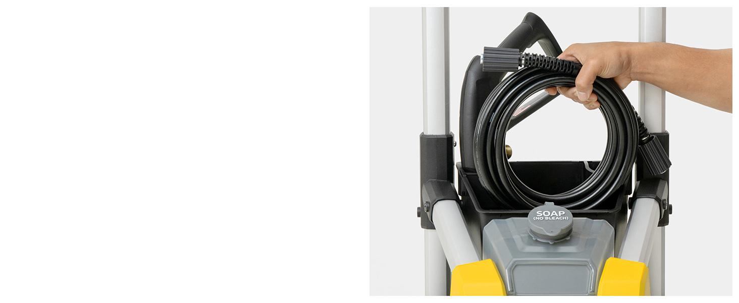 A person placing the pressure washer hose in the onboard storage bin