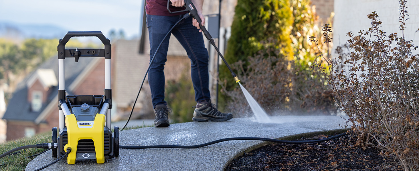 A person cleaning a walkway using the K1700 pressure washer