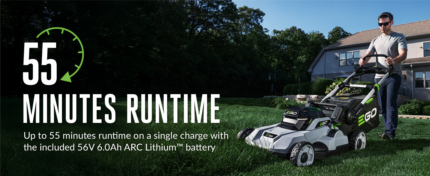 man pushing mower up a hill on partially cut yard to show 55 minute run time of mower